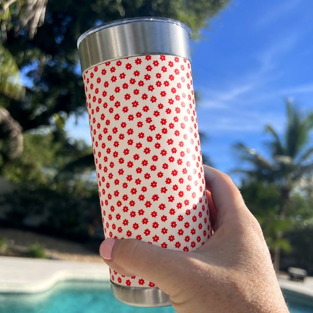 The cream-and-red flipped wrap on a Wrapware tumbler, held up by the pool.