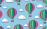 Colorful hot air balloons with rainbow-striped canopies float among small white clouds on a light blue background.