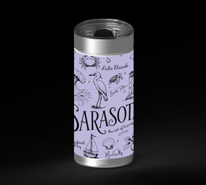 Illustrated Sarasota-themed collage in black line art on a lavender background, with the word “Sarasota” large in the center and smaller place names and coastal icons around it, including waves, shells, dolphins, birds, palms, sailboats, flowers, and buildings.