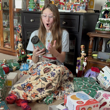 Mary Beth's daughter reacting to her custom tumbler on Christmas morning
