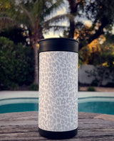 Snow Leopard wrap on a black ceramic Wrapware Tumbler poolside