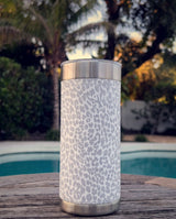 Snow Leopard wrap on a stainless Wrapware Tumbler on a poolside table