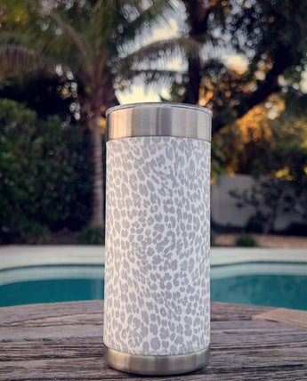 Snow Leopard wrap on a stainless Wrapware Tumbler on a poolside table